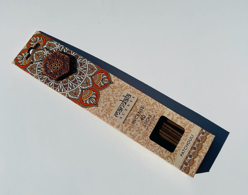 May include: A box of 40 incense sticks with a mandala design on the front. The box is brown and has the text "Mandala Scents" and "Incense Sticks" printed on it. The scent is Patchouli.