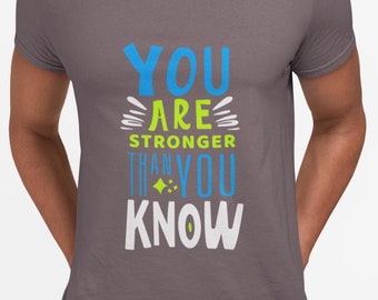 May include: A grey t-shirt with the text "You are stronger than you know" in blue and green lettering.