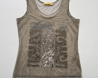 May include: A gray mesh tank top with a white and brown graphic print and rhinestones. The graphic print includes the words "Jungle" and "Tropics".