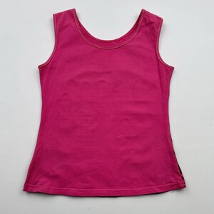 May include: A sleeveless pink tank top with a scoop neck.