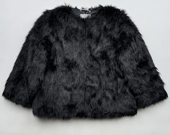 May include: A black faux fur jacket with a zipper closure.
