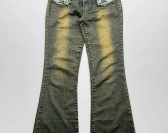 Pantalones vaqueros acampanados estilo vintage Y2K para mujer, de mezclilla azul desgastada con corte bota.