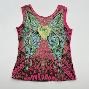 May include: Pink sleeveless tank top with a colorful butterfly design and a heart in the center. The butterfly has green, blue, and yellow wings. The background is a pink and green paisley pattern.