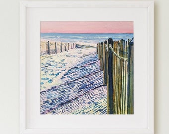 May include: A framed painting of a beach scene. The artwork depicts a sandy beach with a wooden fence and a rope barrier. The sky transitions from pink to blue, and the ocean is visible in the background. The painting is in a white frame.