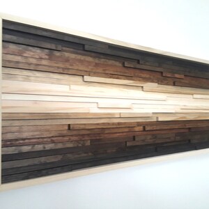 May include: A framed wood wall art piece with a gradient of brown, beige, and white wood strips arranged in a horizontal pattern.