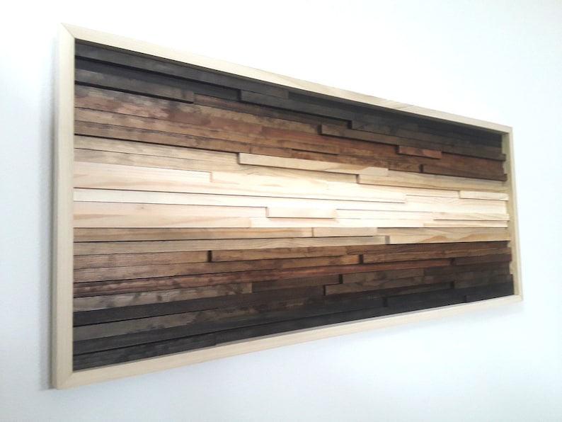 May include: A framed wood wall art piece with a gradient of brown, beige, and white wood strips arranged in a horizontal pattern.