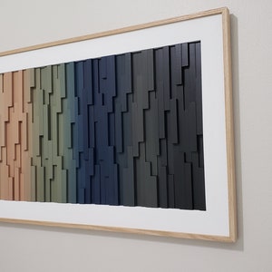 May include: A framed wall art piece with a gradient of colors from white to black. The art is made of wood and has a 3D effect.