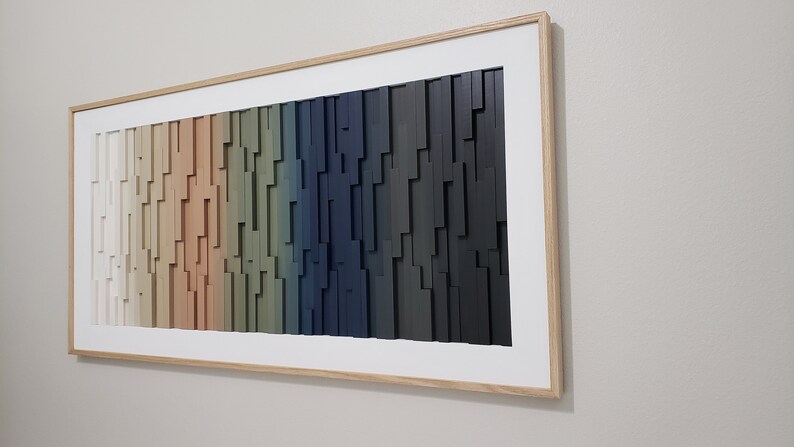 May include: A framed wall art piece with a gradient of colors from white to black. The art is made of wood and has a 3D effect.