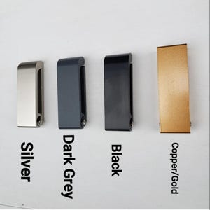 May include: Four metal door handles in different finishes: silver, dark grey, black, and copper/gold.