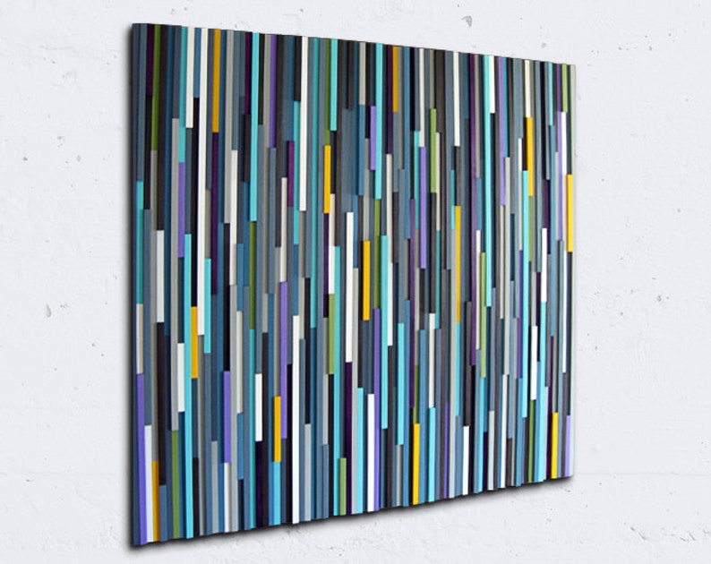 May include: Abstract wall art made of wood with vertical strips of various colours, including blue, teal, purple, yellow, and grey.