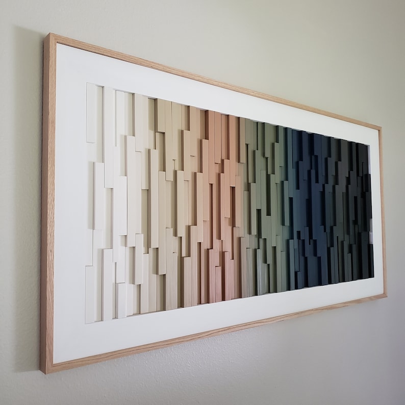 May include: A framed abstract wall art piece with a gradient of colors from white to dark green. The art is made of wood and has a modern, minimalist style.