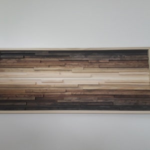 May include: A framed wood wall art piece with a gradient of brown, beige, and white wood pieces arranged in horizontal rows.