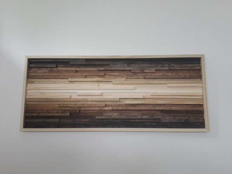 May include: A framed wood wall art piece with a gradient of brown, beige, and white wood pieces arranged in horizontal rows.