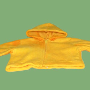 May include: A yellow hooded fleece jacket with a zipper closure.
