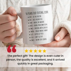 a person holding a coffee mug with five stars
