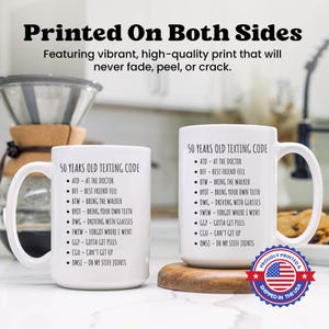 two white coffee mugs sitting on top of a counter