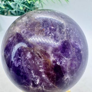 Natural Crystal Purple Amethyst Sphere 2.3” diameter, 268.6 grams, smooth and polished exterior with natural internal cracks.