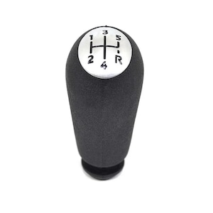 May include: Black gear shift knob with a silver top featuring the numbers 1, 2, 3, 4, 5, and R.