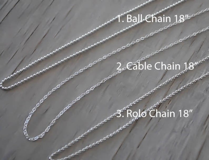May include: Three silver chains, each 18 inches long, are laid out on a wooden surface. The chains are labeled "Ball Chain 18", "Cable Chain 18", and "Rolo Chain 18".