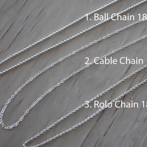 May include: Three silver chains, each 18 inches long, are laid out on a wooden surface. The chains are labeled "Ball Chain 18", "Cable Chain 18", and "Rolo Chain 18".