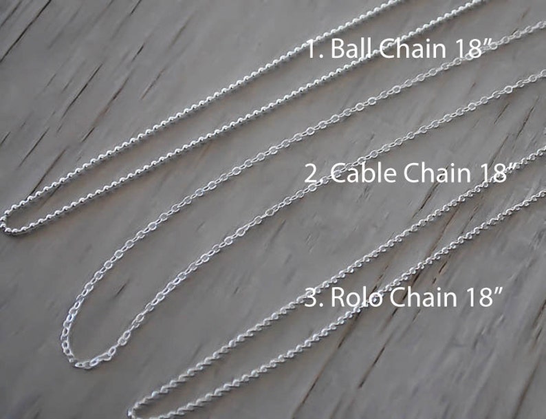 May include: Three silver chains, each 18 inches long, are laid out on a wooden surface. The chains are labeled "Ball Chain 18", "Cable Chain 18", and "Rolo Chain 18".