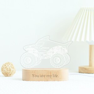 May include: A white LED night light shaped like a monster truck with the name "Grace" etched on it. The light sits on a wooden base with the inscription "You are my life."