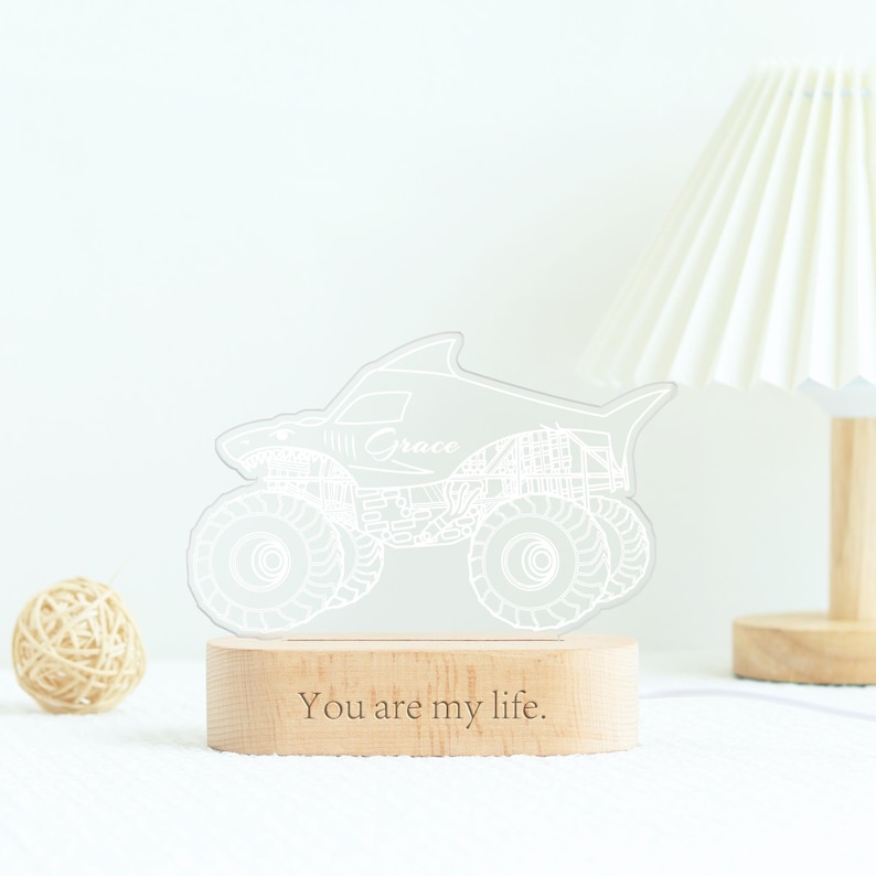 May include: A white LED night light shaped like a monster truck with the name "Grace" etched on it. The light sits on a wooden base with the inscription "You are my life."