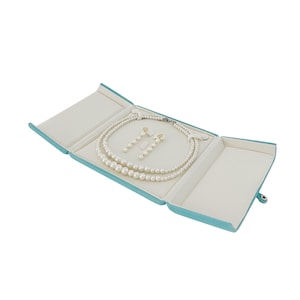 May include: A turquoise blue jewellery box with a white interior, open to reveal a pearl necklace and matching earrings.
