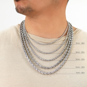 May include: A close-up of a man's neck wearing five different silver rope chains in various lengths. The chains are labelled with their thickness and length in inches: 3mm - 18in, 4mm - 20in, 5mm - 22in, 6mm - 24in, and 7mm - 26in.