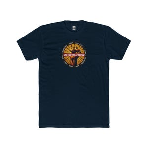 May include: A navy blue t-shirt featuring a yellow and red graphic of a raised fist. The graphic includes the text "UNITED HOLLYWOOD" in red.