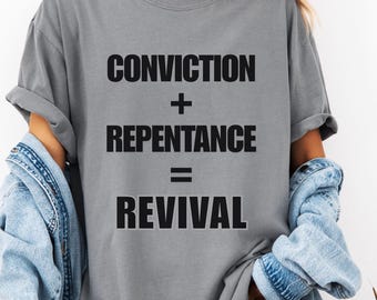May include: Gray t-shirt with the text "Conviction + Repentance = Revival" printed in black.