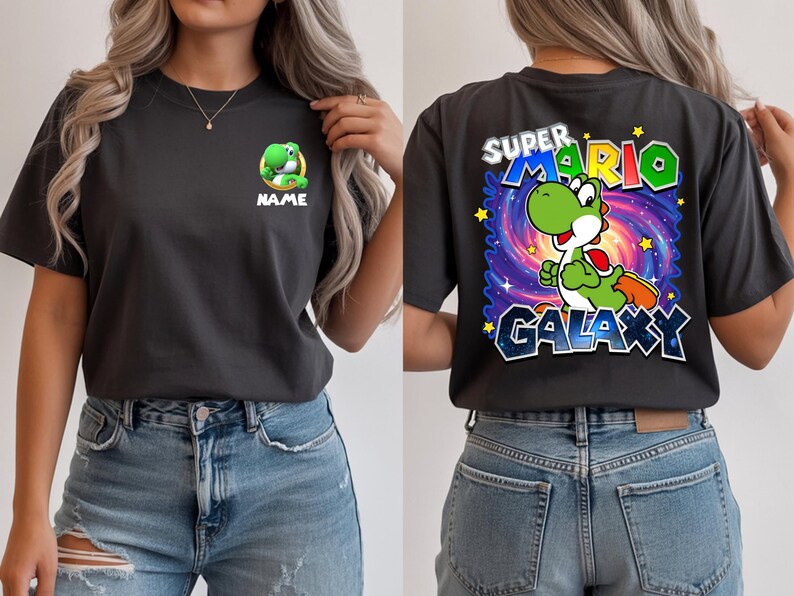May include: Charcoal gray t-shirt featuring a green Yoshi character from Super Mario. The front has a small Yoshi graphic with the word "NAME" below. The back displays "SUPER MARIO GALAXY" with Yoshi in a galaxy-themed background.