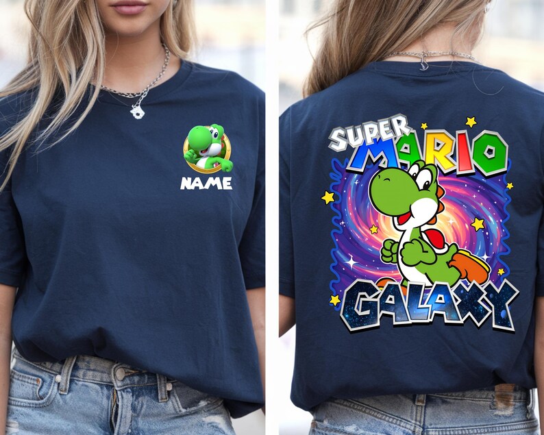 May include: Navy blue t-shirt featuring a green Yoshi character from Super Mario. The front displays Yoshi with the word "NAME" below. The back showcases Yoshi in a galaxy design with the words "SUPER MARIO GALAXY".