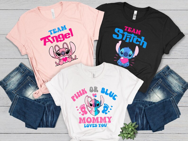 May include: Three t-shirts with a gender reveal theme featuring Stitch and Angel from Lilo & Stitch. The pink shirt says "Team Angel", the blue shirt says "Team Stitch", and the white shirt says "Pink or Blue Mommy Loves You".
