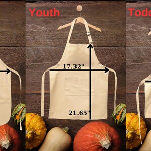 May include: Three beige canvas aprons with adjustable neck straps and a single pocket. The aprons are labeled "Adult", "Youth", and "Toddler" and are shown with measurements in inches.