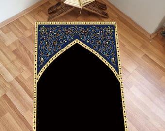 May include: A blue prayer rug with an intricate gold and black design. The rug features a traditional arch shape in the centre.