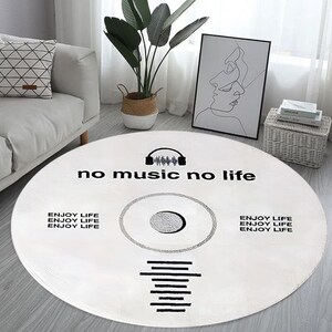 May include: White round rug with a black vinyl record design. The rug has the text "no music no life" and "ENJOY LIFE" repeated three times.