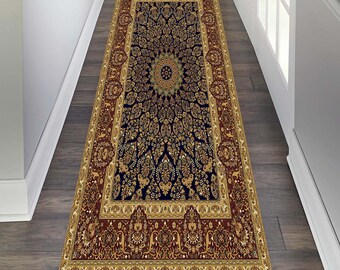 May include: A long, rectangular rug with a navy blue centre featuring a gold and cream floral pattern. The rug has a red border with a gold and cream floral pattern.