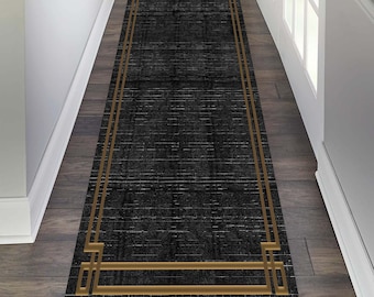 May include: Black and gold patterned runner rug with a geometric border. The rug has a subtle distressed look.
