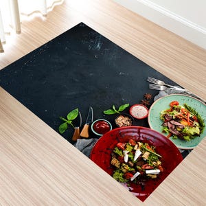May include: Two colorful salad bowls with fresh ingredients on a black background. One bowl is red and the other is green. Both bowls contain lettuce, tomatoes, and other vegetables.