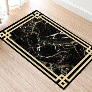 May include: Black and white marble patterned rug with a gold geometric border.