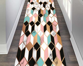 May include: A geometric runner rug with a white marble background and black, gold, pink, and turquoise geometric shapes.