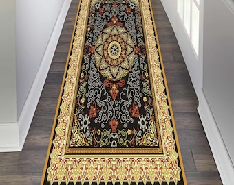 May include: A black and gold patterned runner rug with intricate floral designs. The rug has a black background with gold and red accents. The rug is perfect for adding a touch of elegance to any room.