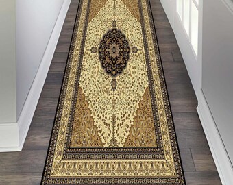 May include: A beige and black patterned runner rug with a floral design. The rug has a black border and a central medallion with a floral pattern.