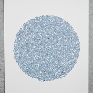 May include: A blue and white abstract print with a circular design. The print is titled "Frozen" and is numbered 5/20.