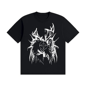 May include: A black short-sleeved t-shirt featuring a white graphic print on the chest. The design depicts a stylised silhouette of a deer with large antlers, surrounded by sharp, jagged lines and a circular crosshair target symbol centred.