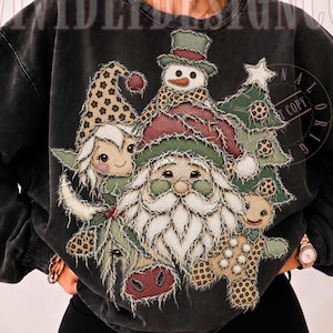 May include: A charcoal gray crewneck sweatshirt featuring a distressed-style graphic print of Santa Claus, a snowman, a gnome, a gingerbread person, and a Christmas tree, all accented with leopard print patterns and frayed edges.