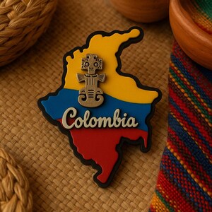 May include: A yellow, blue, and red outline of Colombia with the word "Colombia" written in white. A gold-colored figurine of a person is in the center of the outline.