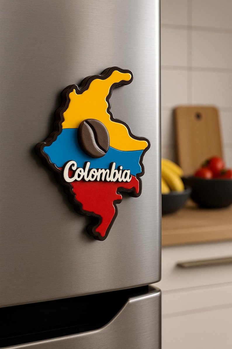 May include: A brown, 3D magnet shaped like the outline of Colombia with the Colombian flag colors: yellow, blue, and red. The magnet has a brown coffee bean in the center and the word "Colombia" written in white.