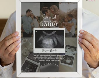 May include: White framed print with family photos, ultrasound images, and text that reads "Surprise! You're going to be a Daddy. See you in November." The print also includes the text "Our love has taken shape and now becomes the most beautiful gift of our lives."